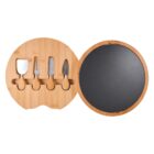 Round bamboo cheese board with a removable slate serving surface. The board is open to show four cheese knives and tools with wooden handles, neatly arranged in dedicated slots on one side.