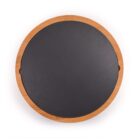 A round cutting board with a wooden edge and a black surface, viewed from above.