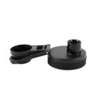 Black plastic water bottle lid with a circular design, flip-open spout, and attached handle. The spout is on the right, and the handle is on the left, connected by a hinge.