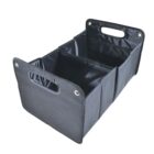 Collapsible storage organizer with three compartments, made of black fabric with reinforced handles and silver button accents on the sides.