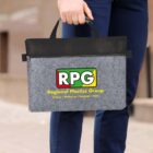 A person holds a gray felt briefcase with a black handle. The briefcase features the logo RPG and the text Regional Plastics Group along with the names of cities: Sydney, Melbourne, Adelaide, Perth. The person is dressed in blue pants.