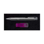 A silver pen and a purple USB drive are placed side by side on a black textured surface.