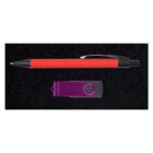 A red pen with a black tip and clip is placed parallel to a purple USB flash drive on a black textured background.