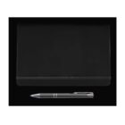 A closed black notebook with an elastic band is placed against a black background. Below it, theres a silver pen with a metallic finish.