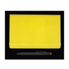 A closed yellow notebook with an elastic band, placed on a black background. Below the notebook is a black pen with a click mechanism and a yellow tip.