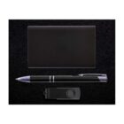 A black business gift set on a dark background, featuring a sleek black pen with silver accents, a black rectangular USB flash drive, and a black business card holder.