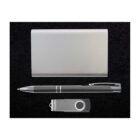 A silver business gift set on a black background, featuring a rectangular card holder, a black pen with silver accents, and a silver USB flash drive.