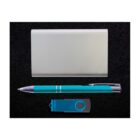 A silver cardholder, a teal pen with silver accents, and a teal USB flash drive are arranged neatly on a black textured background.