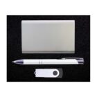 A sleek silver power bank, a white ballpoint pen with black accents, and a white USB flash drive with a black circular design are neatly arranged on a black surface.