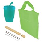 A teal reusable cup with a sip lid, a light green reusable shopping bag with handles, two metal straws, a straw cleaning brush, and a bamboo case are displayed against a white background.
