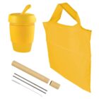 Yellow reusable items including a cup with a lid, a tote bag, a bamboo straw with a metal cleaning brush, and a metal drinking straw, all arranged neatly on a white background.