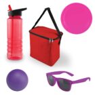 A collection of items including a red water bottle with a black cap, a red insulated lunch bag with a black handle, a pink flying disc, a purple ball, and purple sunglasses with dark lenses.