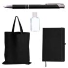 A collection of office items: a black pen at the top, a clear hand sanitizer bottle in the center, a black tote bag on the left, and a black notebook with a ribbon bookmark on the right, all set against a white background.