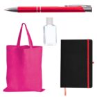 A set of items including a red pen, a small clear bottle, a pink tote bag, and a black notebook with a red elastic band lies on a white background.