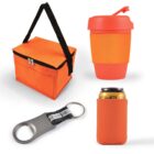 Image of four items: an orange insulated lunch bag with a black strap, an orange reusable cup with a lid, a bottle opener with a key ring, and an orange can cooler sleeve.