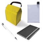 A yellow lunch bag with a black handle, a rectangular clear water bottle, a black notebook with a white elastic band, and a silver and white pen are arranged on a white background.
