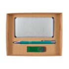 A gift set displayed in a brown box, containing a silver notebook, a green and silver pen, and a green USB flash drive.