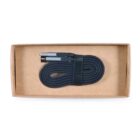A coiled black cable with metallic connectors is neatly placed inside a plain cardboard box. The cable is secured with a black strap and fills most of the boxs interior space.