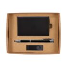 A box containing a black cardholder, a black and silver pen, and a black USB drive, all neatly arranged on a brown cardboard base.