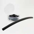 A black, flexible cylindrical tube is laid in front of a small, round clear container with a lid, which holds more of the same tubing coiled inside. The container is open, and the background is a plain white.