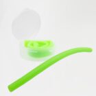 A flexible, bright green silicone straw is shown, with one portion coiled inside a small, open white container. The straw is reusable and eco-friendly, intended for drinking beverages.