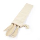 A set of beige-colored reusable utensils, including a fork, spoon, and knife, is partially slid out of a cream-colored fabric pouch with a drawstring on a white background.