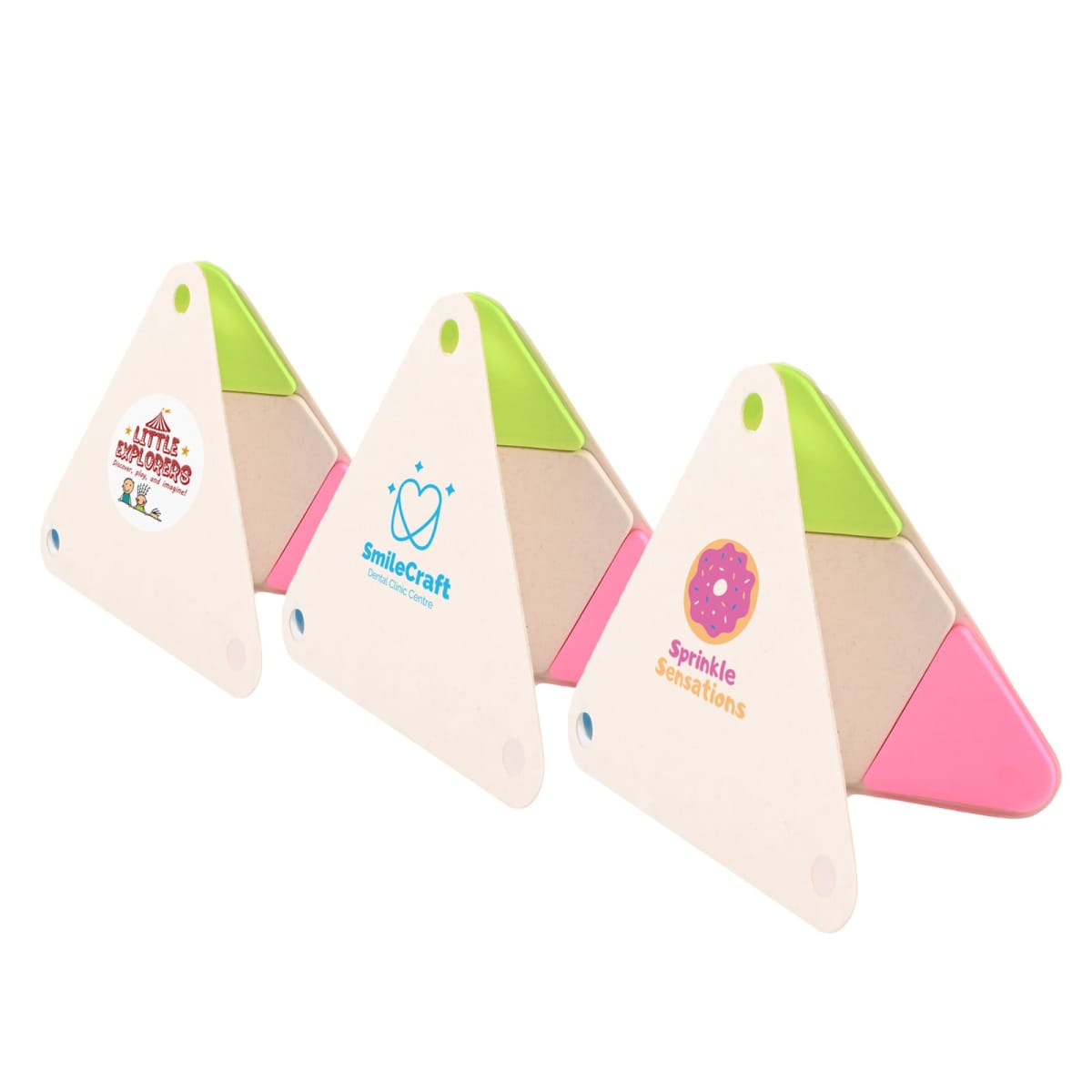 Three triangular promotional items with logos: Little Explorers with a mountain, SmileCraft with a smiling heart, and Sprinkle Sensations with a pink donut. Each triangle has green and pink sections.