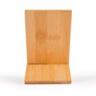 Wooden phone stand with a simple, minimalist design. The stand features a vertical slot to hold a phone upright, ideal for hands-free use. Made of a light brown wood that shows natural grain patterns on a white background.