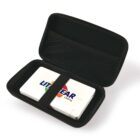 A small black zippered case is open, revealing a white device secured by an elastic strap. The device has a Littman Clearing logo on it. The inside of the case lid has a mesh pocket.