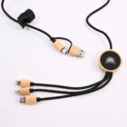 A multi-connector charging cable with a wooden finish and black braided wire. It includes USB, USB-C, and Lightning connectors. One end has a circular wooden piece with a sunburst logo, and a Velcro strap for cable management.