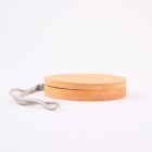 Round wooden yo-yo with a smooth finish, lying on its side. A gray string is attached to the yo-yos center and extends to the left. The background is white.
