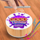 A hand hovers over a cylindrical device labeled Good Times Online Appliances on a wooden surface. Music notes and colorful swirls emerge from the device, suggesting sound or music playing.