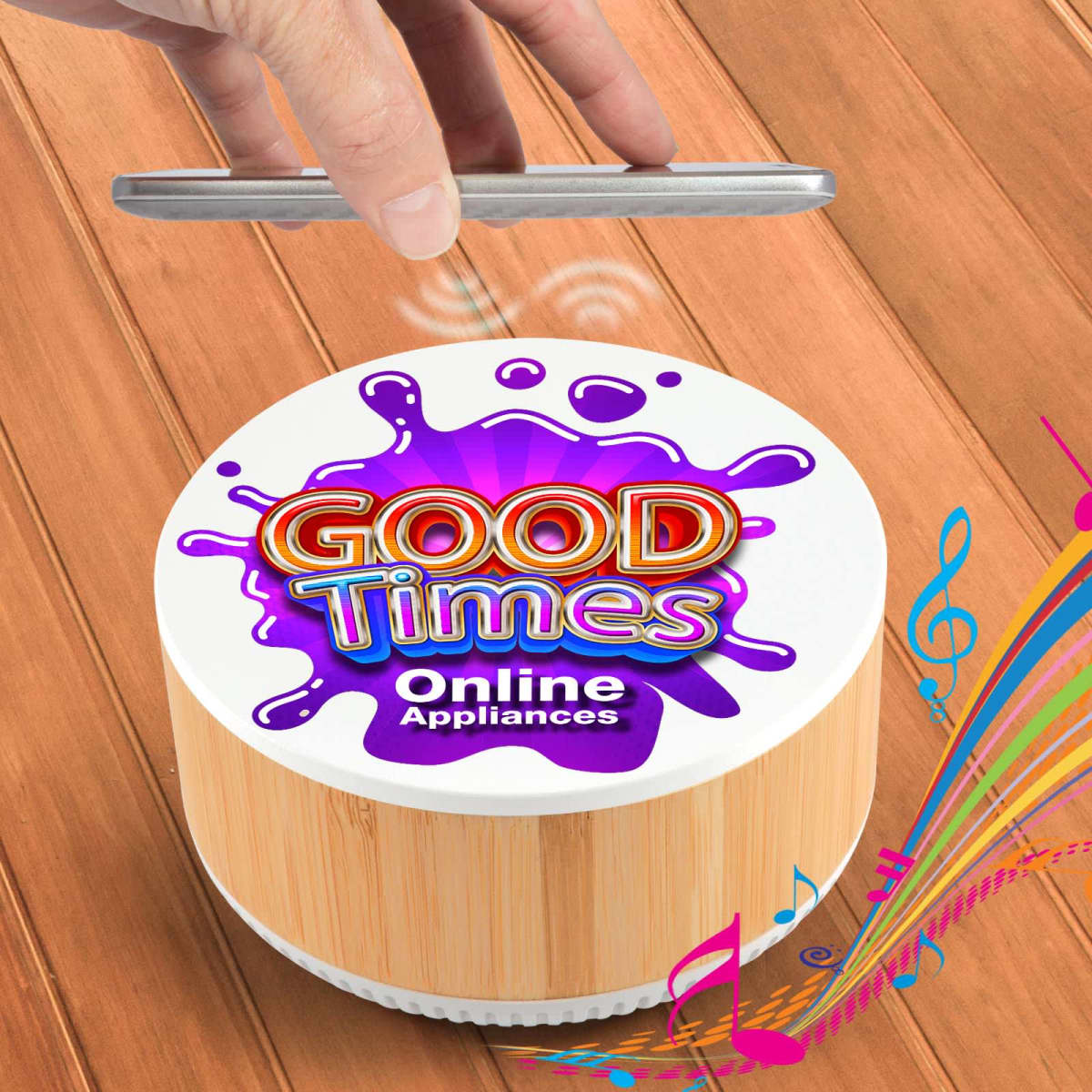A hand hovers over a cylindrical device labeled Good Times Online Appliances on a wooden surface. Music notes and colorful swirls emerge from the device, suggesting sound or music playing.