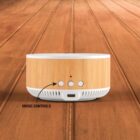 A wooden Bluetooth speaker on a wooden surface, featuring a USB-C charging port and three circular buttons labeled as music controls.