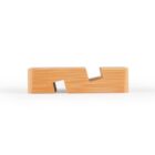 A wooden block with a diagonal indentation in the center, creating a step-like shape. The light wood grain is visible, and the block is placed against a white background.