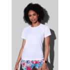 Person in white shirt and colorful shorts against a gray background.