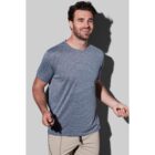 Man in gray T-shirt and beige pants smiling, holding a jump rope.