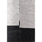 Close-up of a gray textured shirt over dark pants with a side slit detail.
