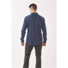 Man in a blue shirt and black pants, viewed from the back, against a plain white background.