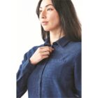 Person with long hair wearing a blue button-up shirt, facing slightly to the side.