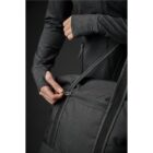Person in dark clothing zipping a black bag close-up.