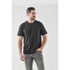 Man in a black T-shirt and jeans standing against a plain white background.