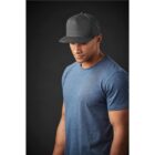 Man in gray cap and blue shirt against dark background.