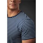Person wearing a blue and white striped shirt against a dark background.