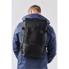 Person in a blue jacket wearing a black backpack.
