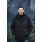 Man in a black jacket stands outdoors with a mountainous background.