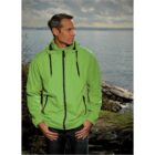 Man in a bright green jacket stands by a lake with cloudy sky.