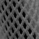 Close-up of a grey mesh fabric with diamond-shaped openings.