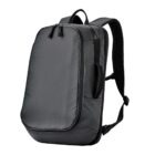 Black minimalist backpack with curved edges and adjustable shoulder straps.