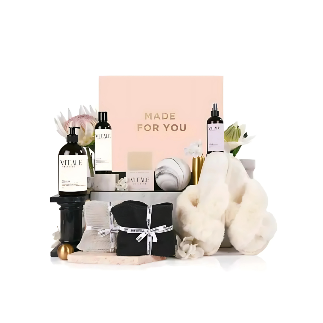 Indulge with Wellbea gift sets: lotions, candles, slippers, flowers, & Made for You sign.
